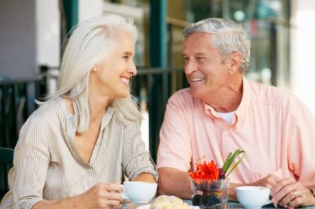Retirement Readiness Guide with elderly couple having breakfast and coffee at a cafe table.