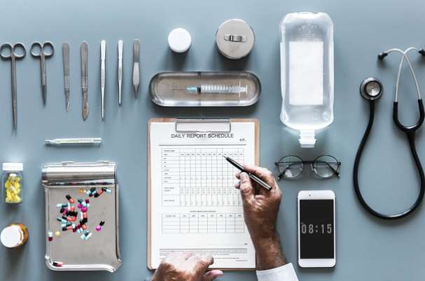 Retirement Health Care Needs daily report list and medical supplies on table.
