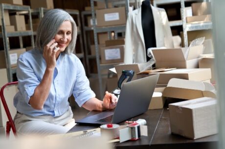 Elderly business own chatting on phone for third-party sales proposition.