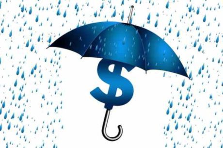 Irrevocable life insurance trusts with umbrella covering dollar sign from rain.