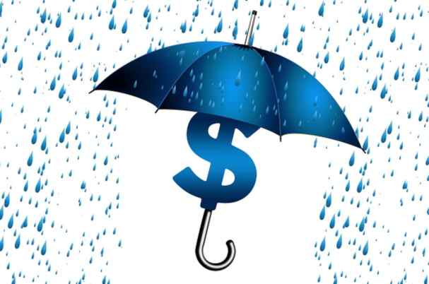 Irrevocable life insurance trusts with umbrella covering dollar sign from rain.