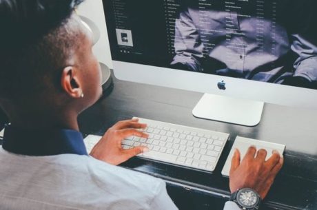 Student loan repayment image of man searching on computer
