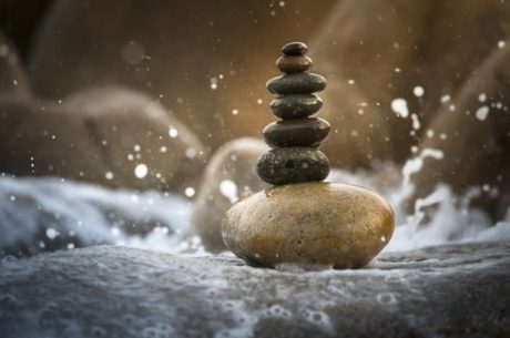 Asset protection plan image shows stacked stones in splashing water.