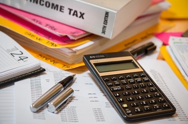 IRS withholding tool photo shows tax documents and calculator