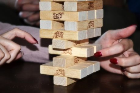 Bonds and bond funds shows strategy image with woman playing Jenga.