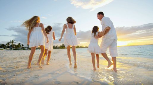The image for the about us page is depicted by a family enjoying running on the beach at sunset.