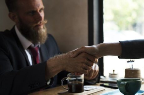 Buy-sell agreement with business owners shaking hands.