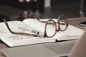 Glasses on a journal indicating doing research.