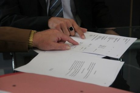 Tax Strategies with two accountants pointing to information on a financial document.