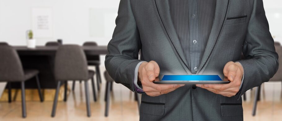 Man in suit holding tablet and wondering if you are making the most of your employer sponsored 401(k) and other plans?