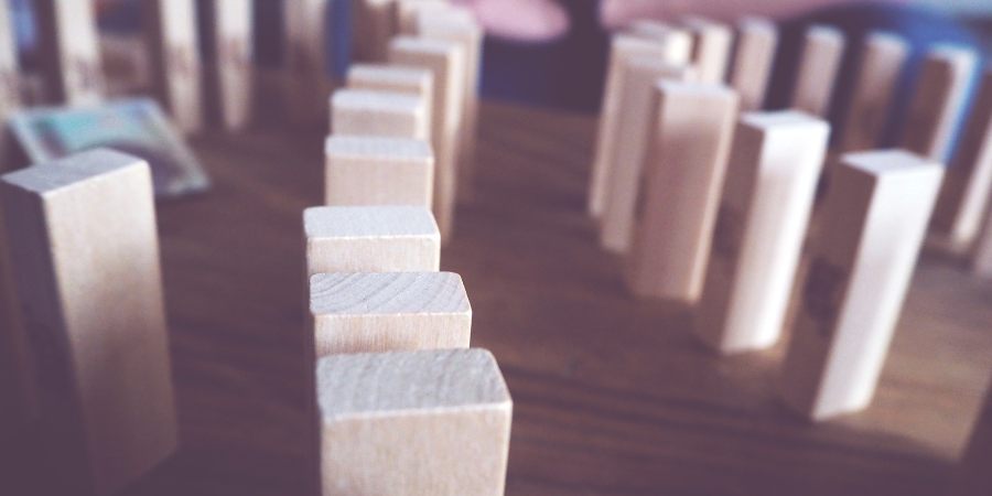 Wood blocks lined up in rows represent asset allocation.