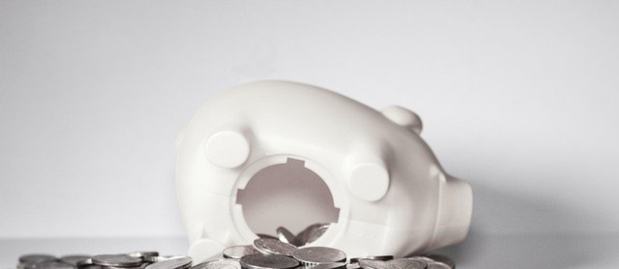 Top 10 Retirement Plan Questions shows open piggy bank laying on side.