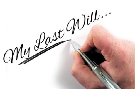 Executor guide shows man's hand writing last will words.
