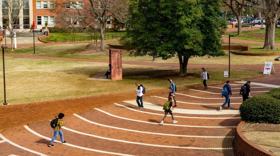 COVID-19 on Campus depicts college students walking on campus.