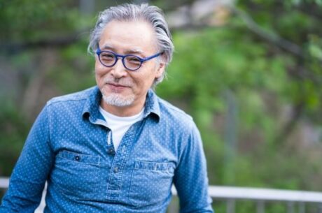 Preparing for Medicare enrollment image shows elderly man smiling at camera.