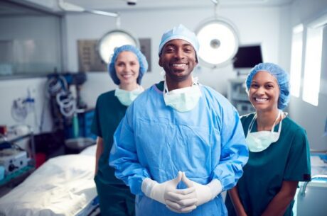 Curbing the Cost of Healthcare Shows a Doctor and Nurses in an Operating Room.