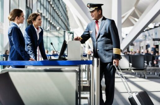 Financial planning and investment management for pilots and airline professionals shows pilot chatting in airport with airline staff.