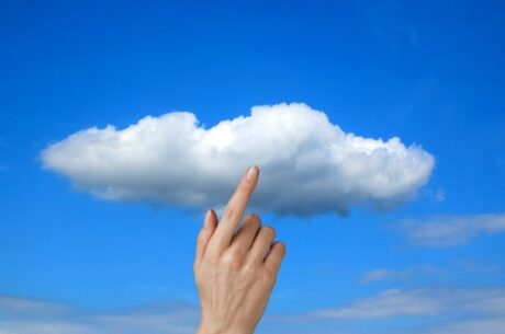 Choosing a Cloud Provider for Storage and Backup Depicts Hand Touching a Cloud.