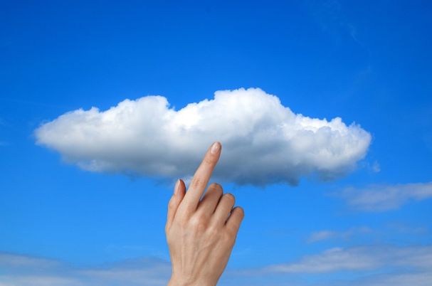 Choosing a Cloud Provider for Storage and Backup Depicts Hand Touching a Cloud.
