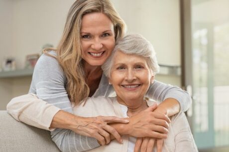 Guide to Medicare Planning with younger woman hugging her elderly mother.