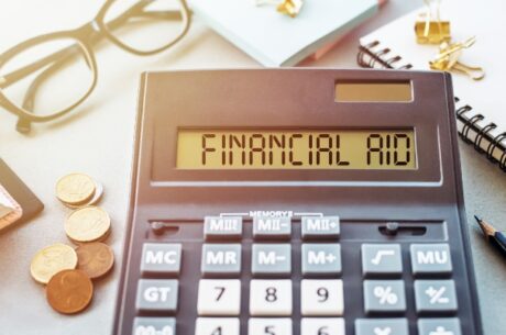 A Crash Course in 529 Plans and Their Impact on Financial Aid photo of calculator.