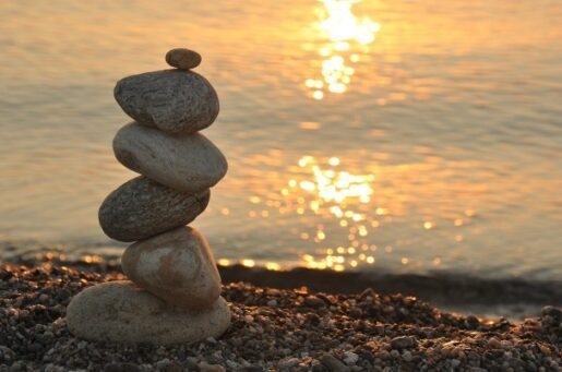 Aging and Mental Health photo of stacked stones on beach.