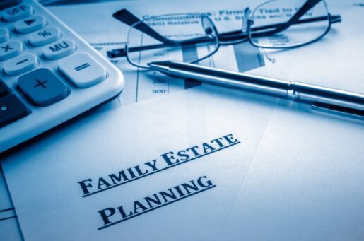 Estate Planning photo of paper, pen, glasses and calculator.