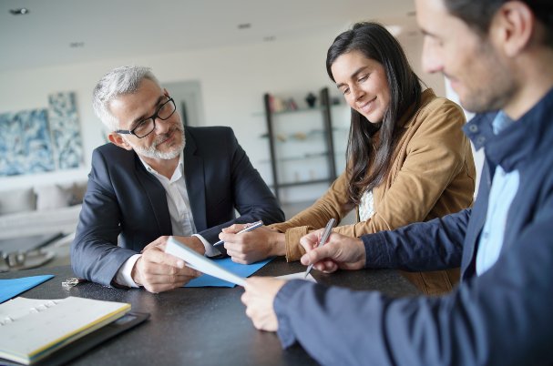 Family business transition with attractive couple signing contract