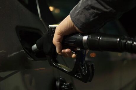 Man pumps gas in car as gasoline prices are on the increase..