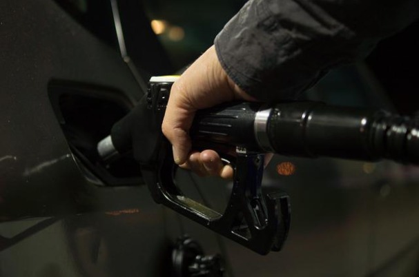 Man pumps gas in car as gasoline prices are on the increase..