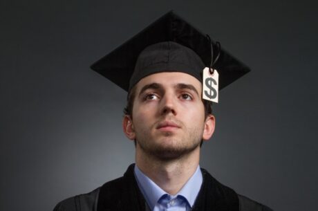 Male college student contemplates student debt relief plans.