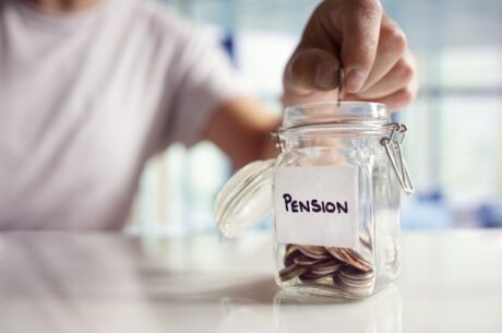 Pension payout options concept shows a person dropping coins in a jar labeled pension.