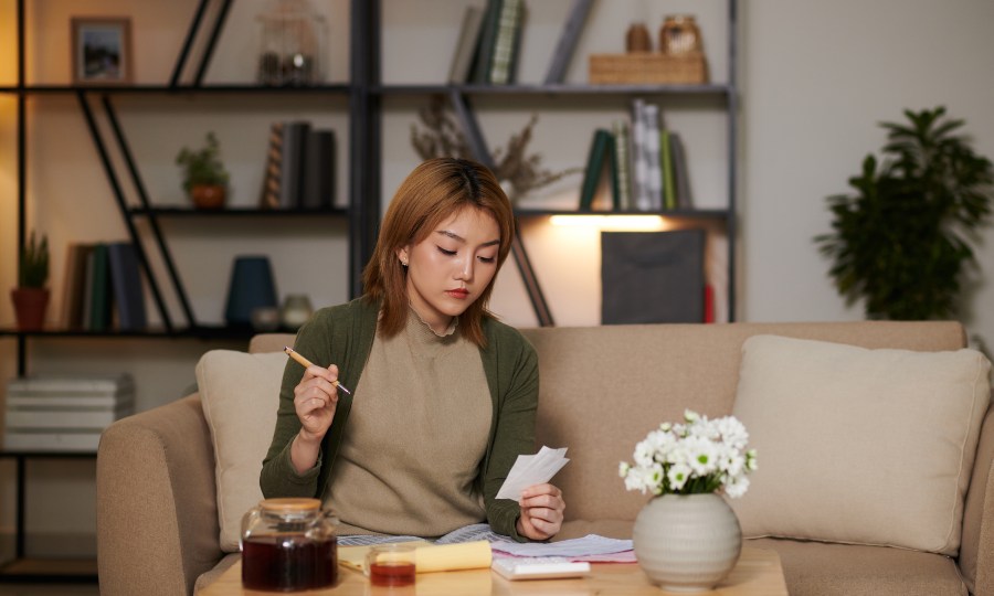 Personal Finance Edition Concept with Young Woman Working on her Budget.