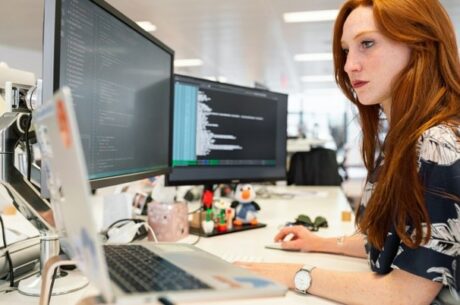 What Plan Sponsors Need to Know About SECURE 2.0 and Its Effect on Retirement Plans Concept Image With Young Woman Working on Computer at her Desk.