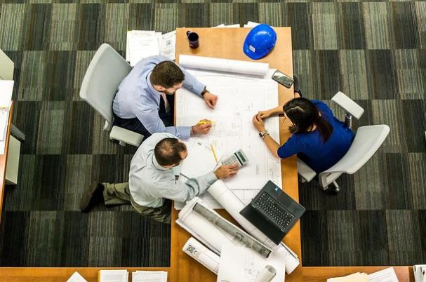 SECURE 2.0: Workplace Retirement Plan Startup Tax Credits Concept with Three Business People Sitting Around a Work Table