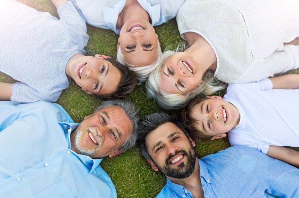 Planning for Young Families Case Study photo concept with family lying in circle with heads together.