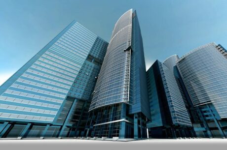 A shot of tall bank buildings depicts The Week of Bank Collapses: A Q&A